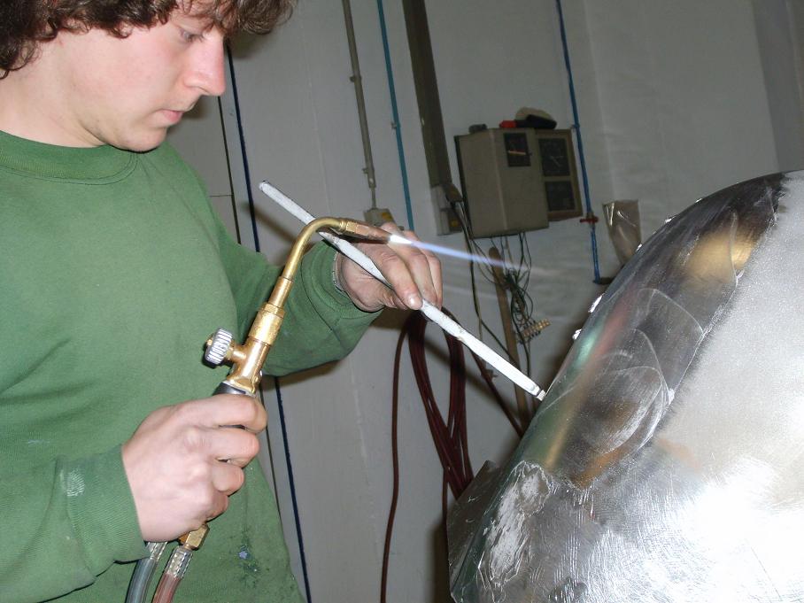 Verzinnen einer Oldtimer Karosserie, diese traditionelle Handwerkskunst muß sehr sorgfältig ausgeführt werden, um Korrosion durch Säurereste zu vermeiden. 